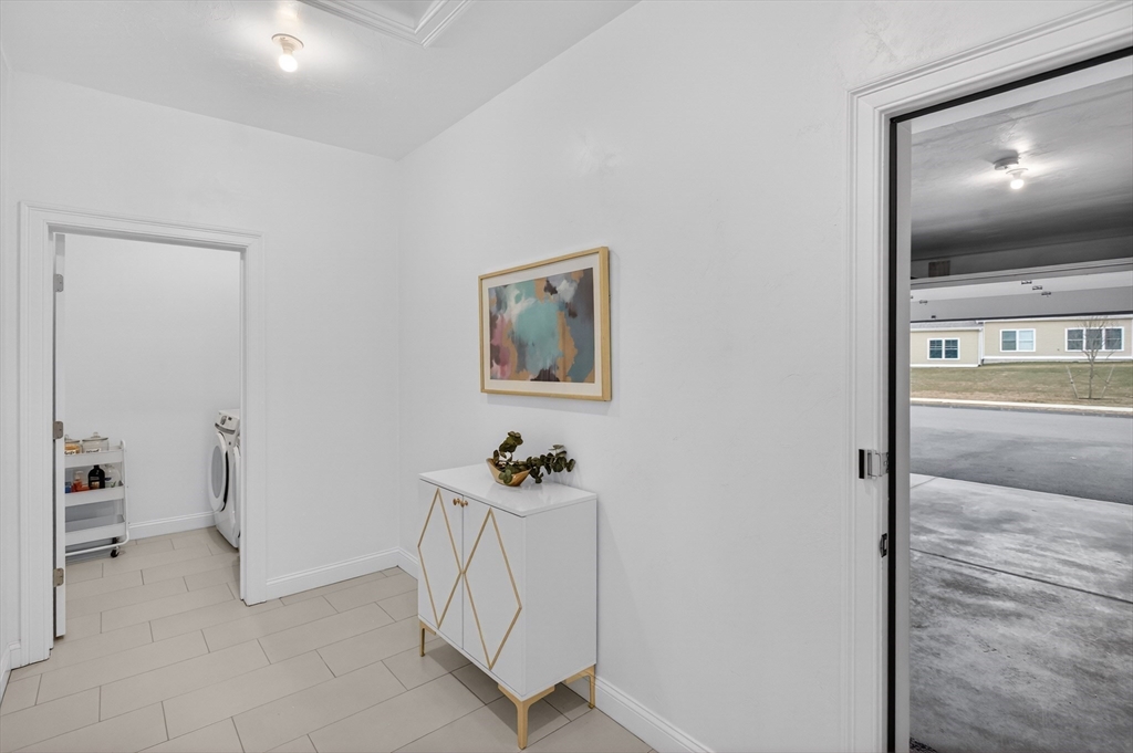 10 Logans Run, Unit 10 Millbury, MA 01527 - Photo 5 of 42 a view of a hallway with workspace
