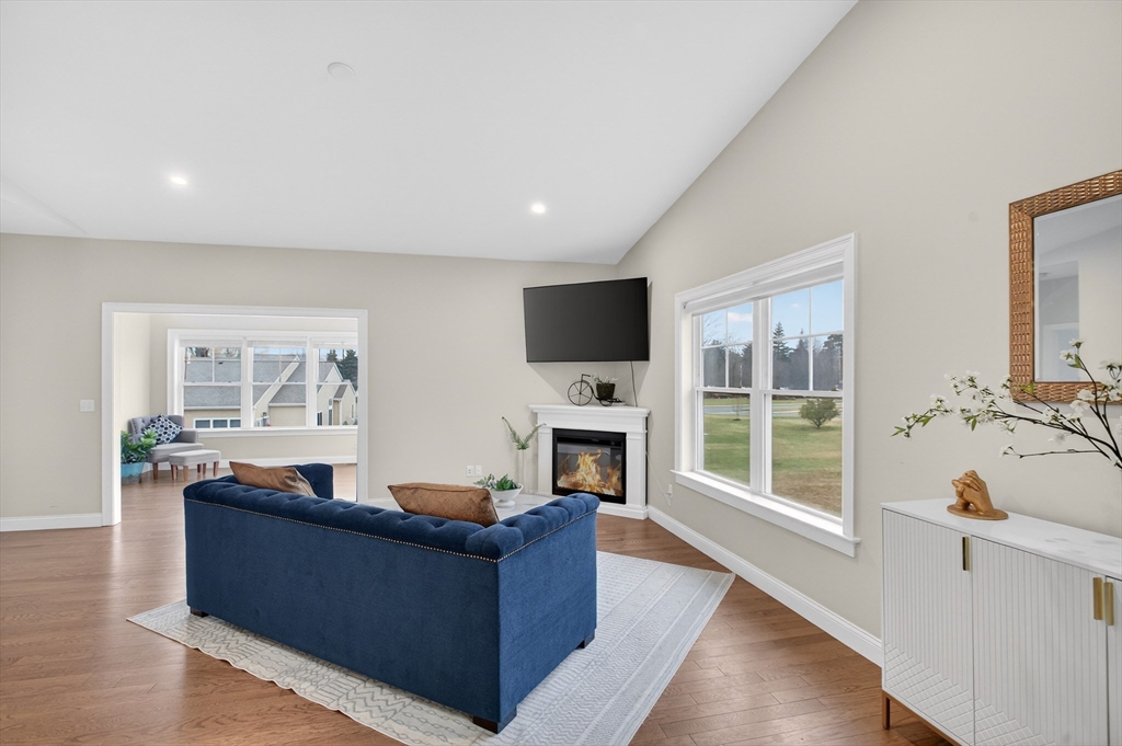 10 Logans Run, Unit 10 Millbury, MA 01527 - Photo 10 of 42 a living room with fireplace furniture and a flat screen tv