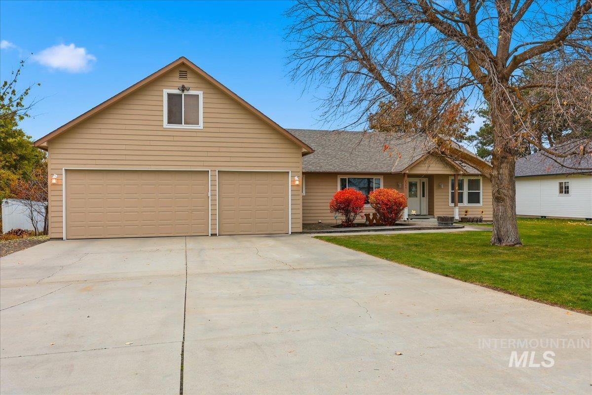 2345 Center Avenue Payette, ID 83661 - Photo 1 of 1 View of front of property with driveway, a front yard, covered porch, and roof with shingles