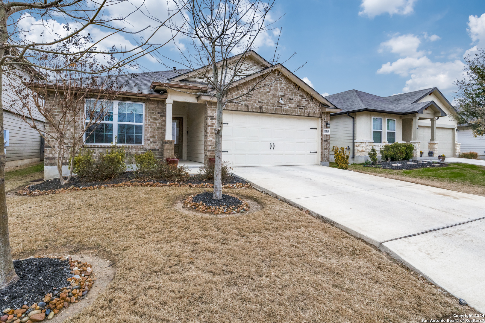 13515 Wild Rye San Antonio, TX 78254 - Photo 1 of 1 a front view of a house with a yard and garage
