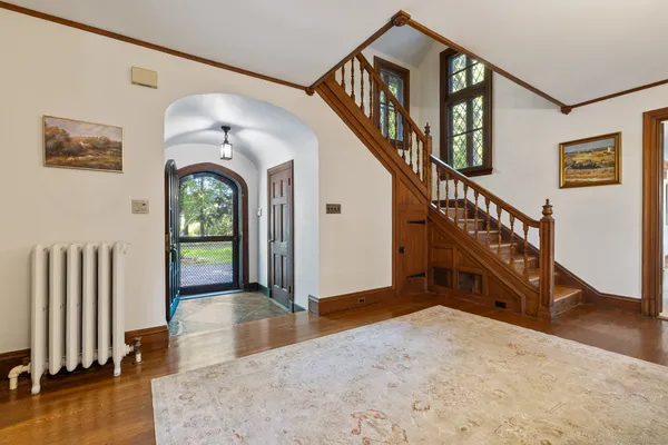 a view of entryway and hall with wooden floor