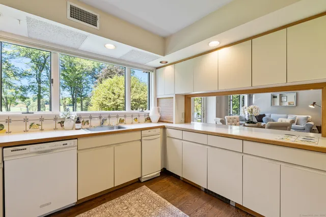 a kitchen with sink attached with living room