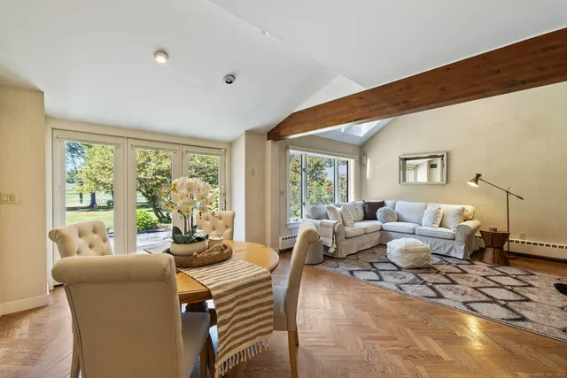 a living room with furniture and large windows