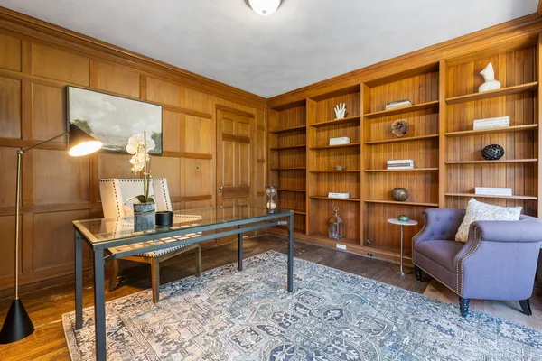 a reading room with furniture rug and a window