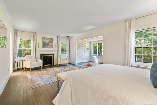 a spacious bedroom with a bed and a fireplace