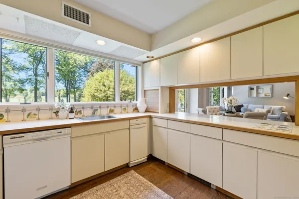 a kitchen with sink attached with living room