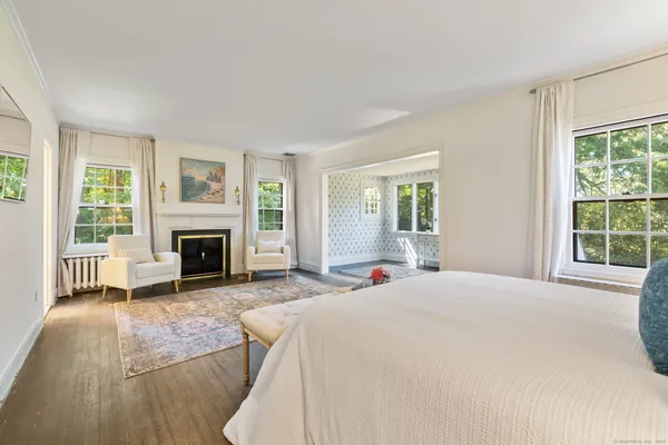 a spacious bedroom with a bed and a fireplace