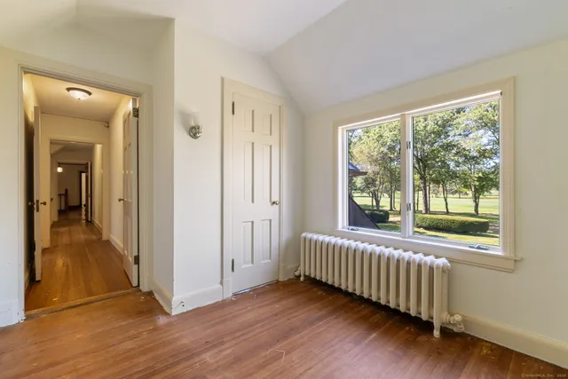 a view of a room with wooden floor and windows