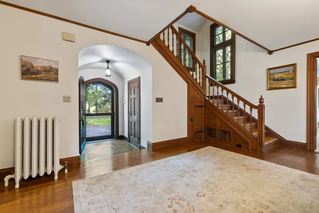 a view of entryway and hall with wooden floor
