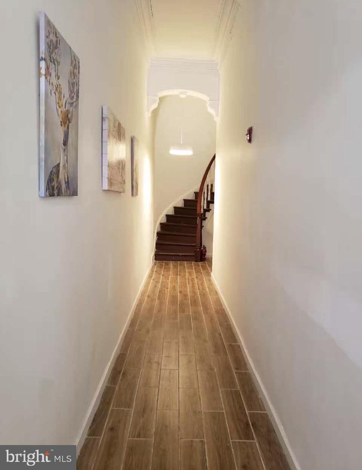 1100-2 Spruce Street, Unit 2F Philadelphia, PA 19107 - Photo 11 of 11 a view of a hallway with wooden floor and staircase