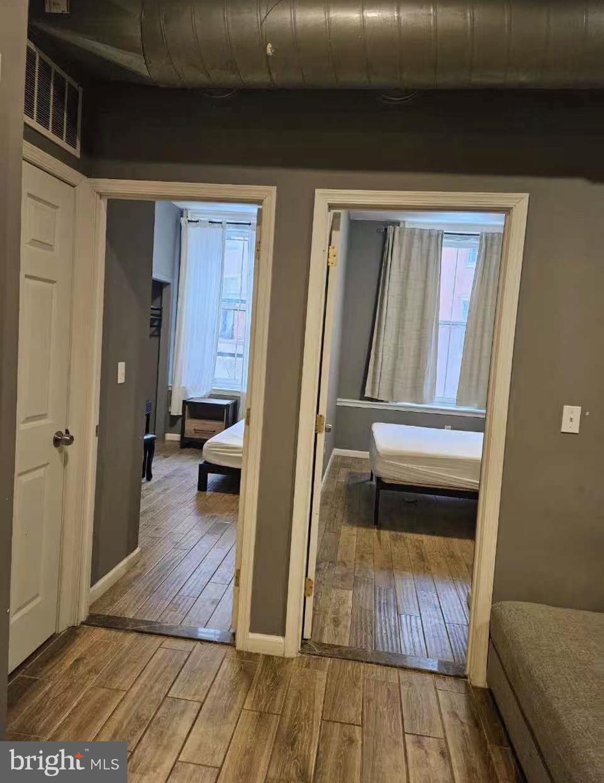 1100-2 Spruce Street, Unit 2F Philadelphia, PA 19107 - Photo 3 of 11 a hallway with wooden floor and furniture
