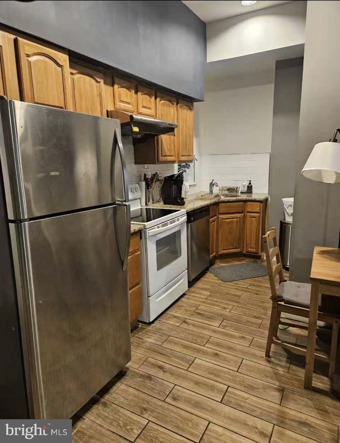 1100-2 Spruce Street, Unit 2F Philadelphia, PA 19107 - Photo 7 of 11 a kitchen with a refrigerator a stove top oven a sink and dishwasher