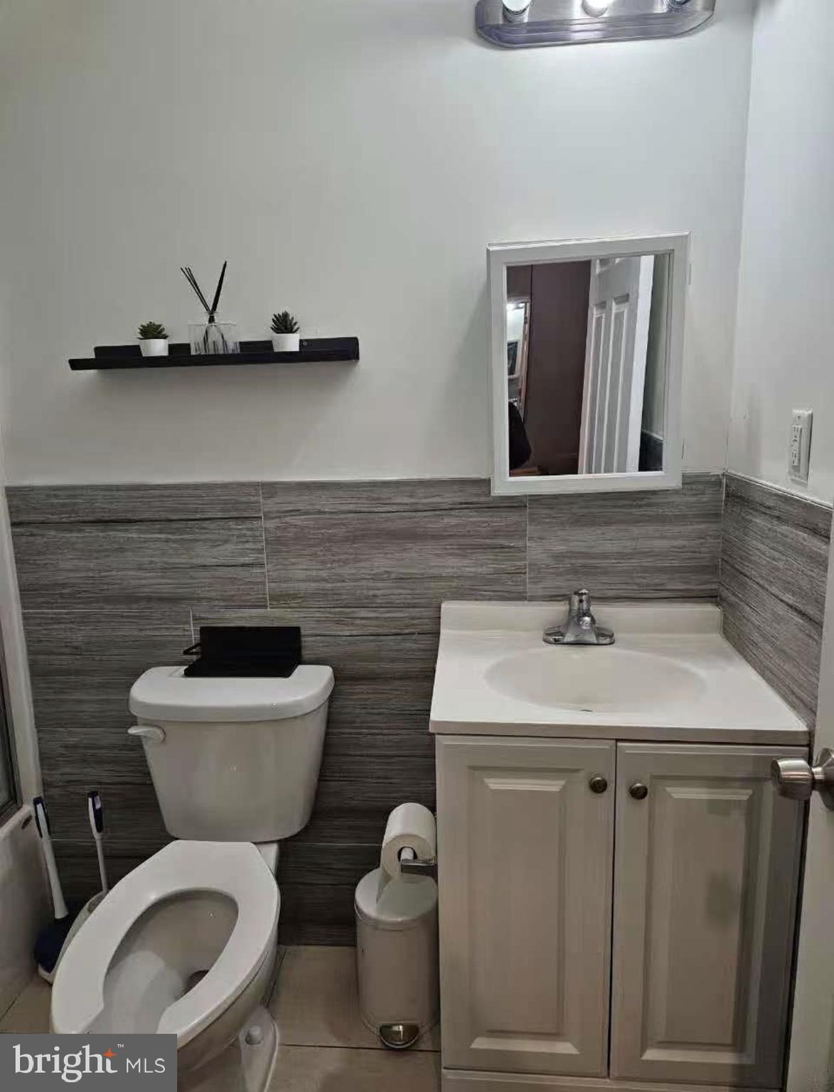 1100-2 Spruce Street, Unit 2F Philadelphia, PA 19107 - Photo 8 of 11 a bathroom with a toilet sink and mirror