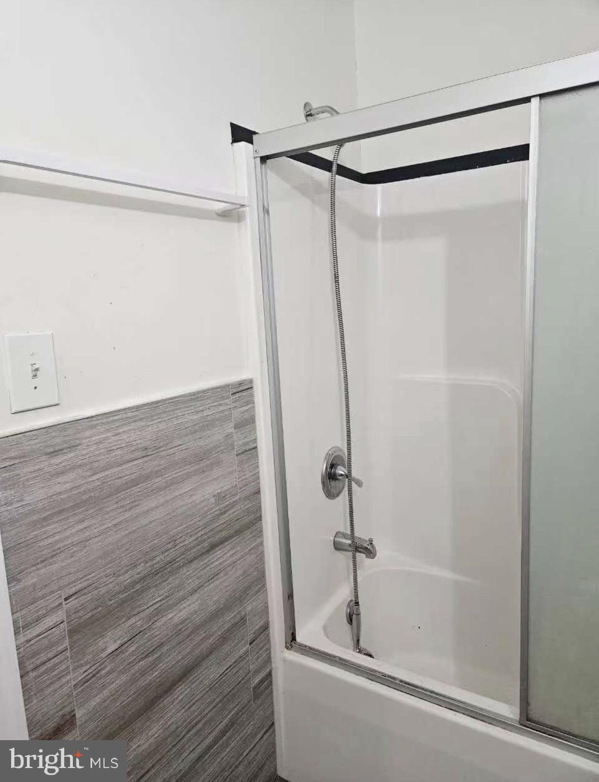 1100-2 Spruce Street, Unit 2F Philadelphia, PA 19107 - Photo 9 of 11 a bathroom with a shower and a glass door