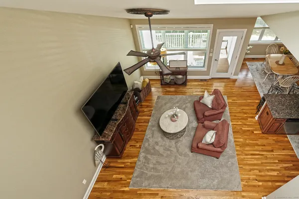 a living room with furniture and a view of kitchen