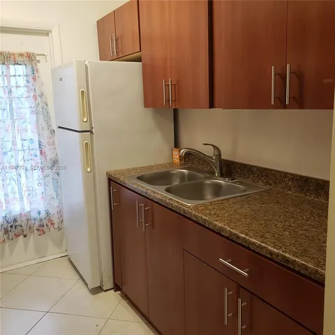 a kitchen with a sink and a refrigerator