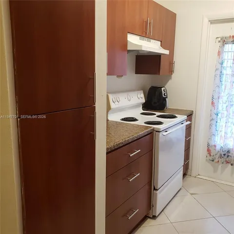 a kitchen with a stove and a microwave