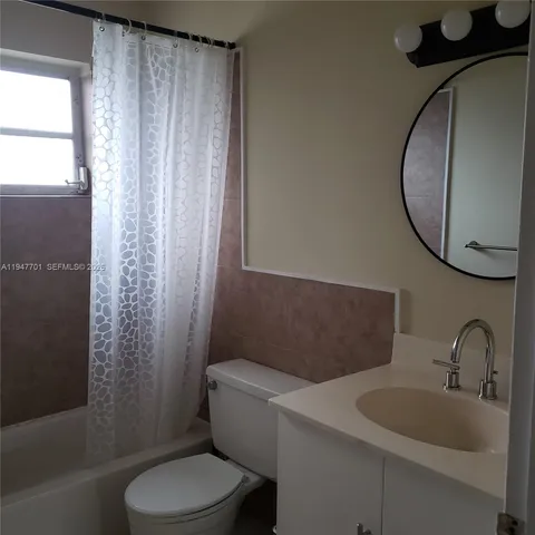 a bathroom with a toilet a sink and a mirror