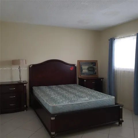 a bedroom with a bed and dresser