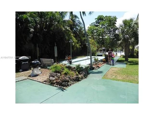 a view of a park with large trees