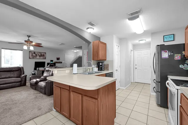 a large kitchen with a large counter top appliances and cabinets