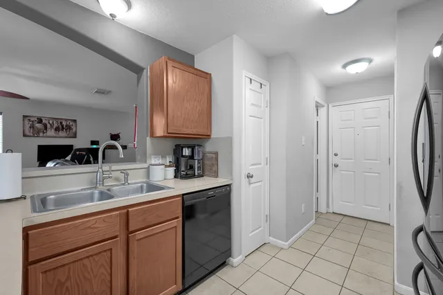a kitchen with a sink cabinets and appliances