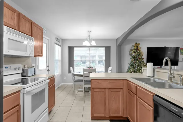 a kitchen with a sink stove and cabinets