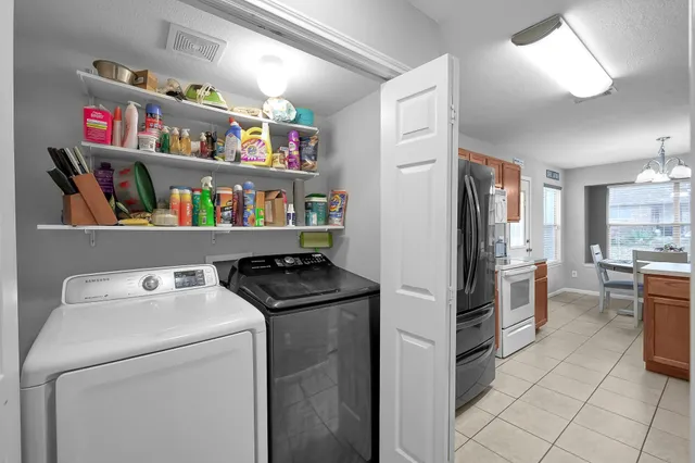 a room with refrigerator and cabinets