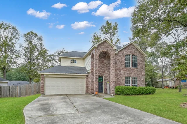 a front view of a house with a garden and yard