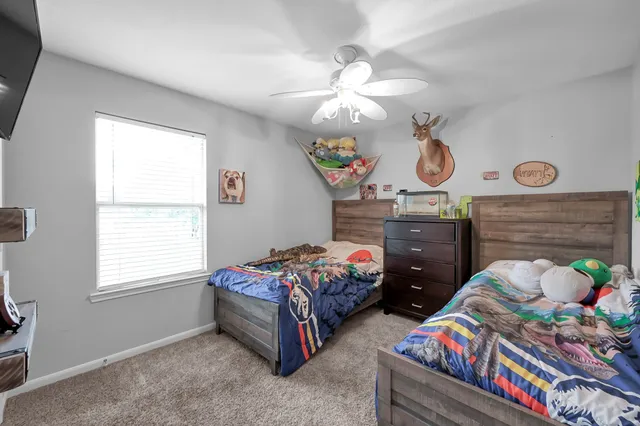 a bedroom with bed and a window