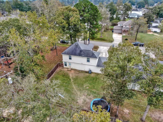 an aerial view of a house with outdoor space
