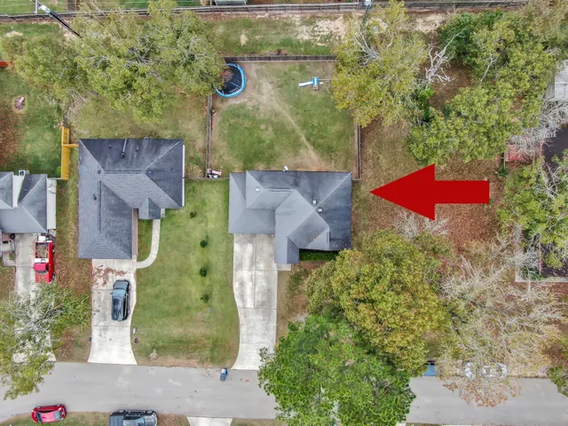 an aerial view of residential houses with outdoor space and street view