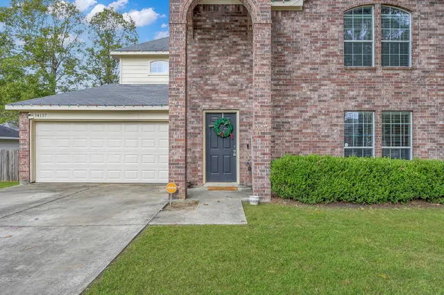 a front view of a house with a yard and garage
