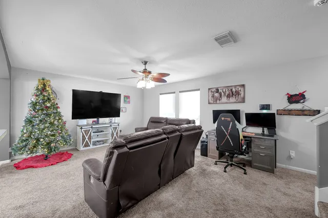 a view of a livingroom with workspace and a couch