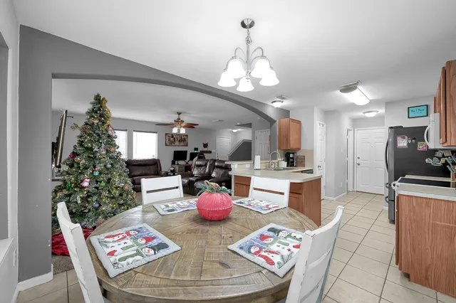 a very nice looking dining room with a table chairs and a kitchen view