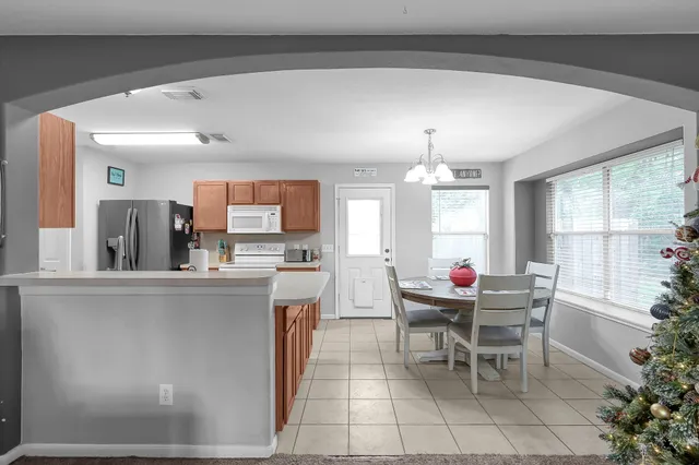 a dining room with furniture and window