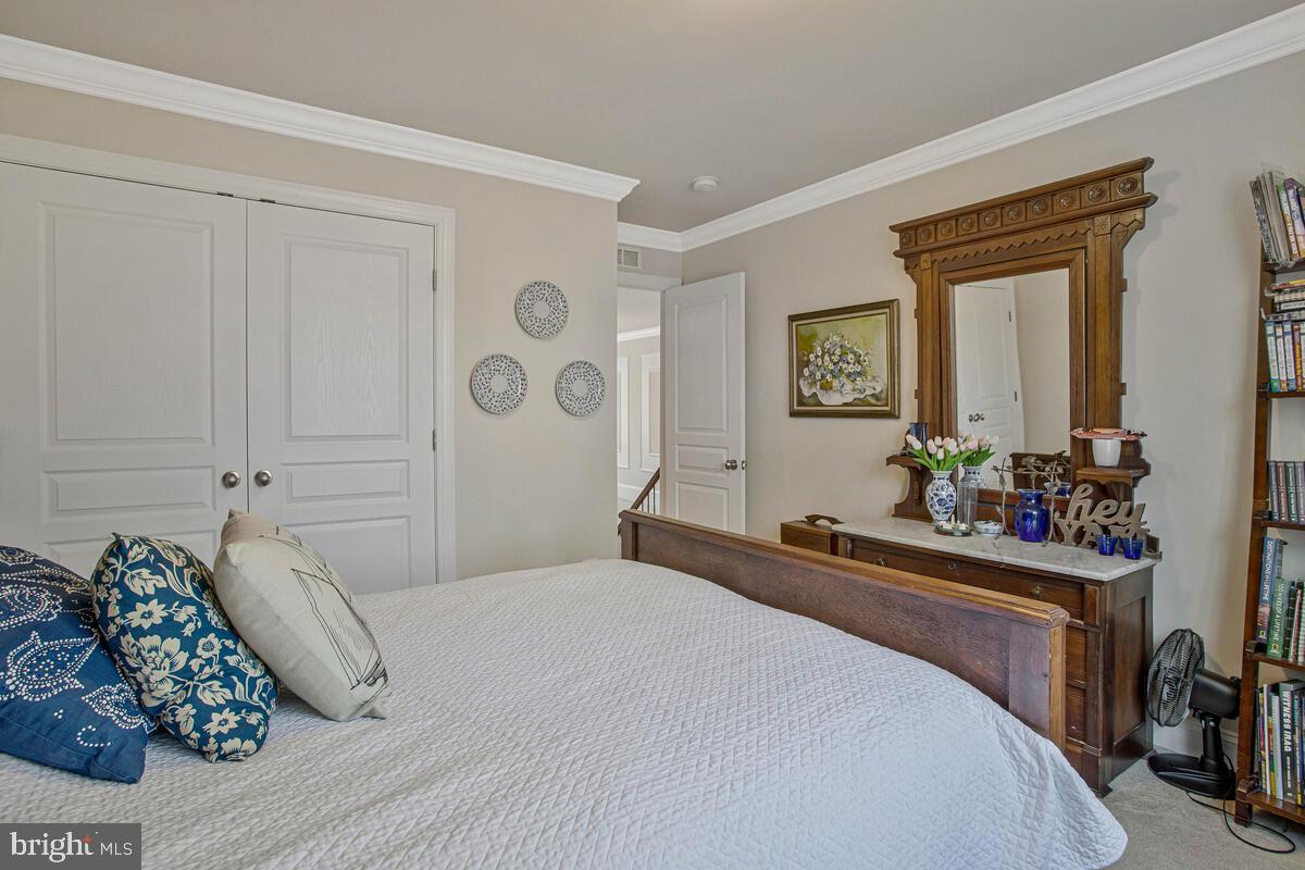 54 Simmons Ridge Road Prince Frederick, MD 20678 - Photo 25 of 55 a bedroom with a bed and a mirror