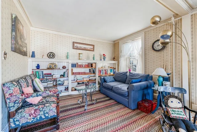 a living room with furniture a rug and a window