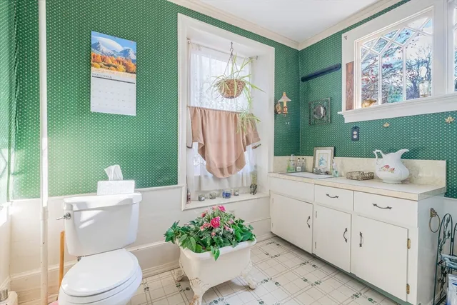 a bathroom with a sink mirror and toilet