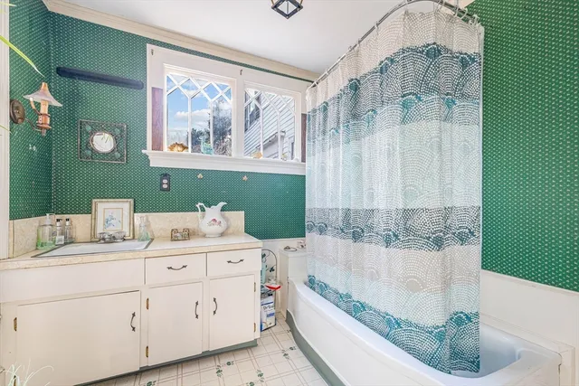 a bathroom with a tub sink and mirror