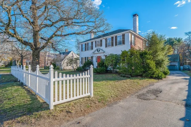 a view of a house with wooden fence