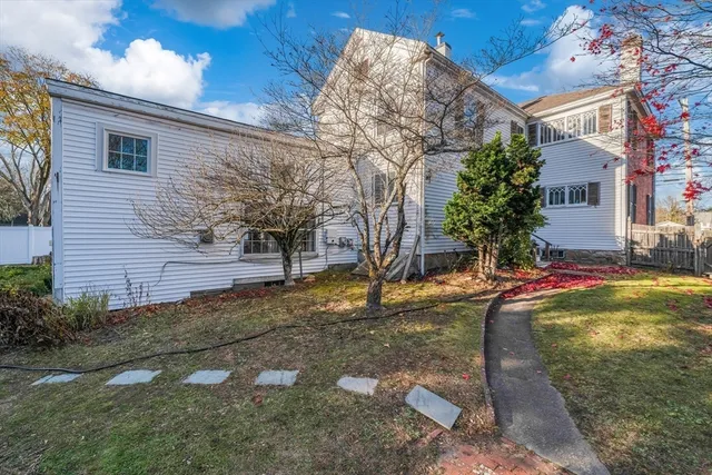 a view of a house with a yard and plants