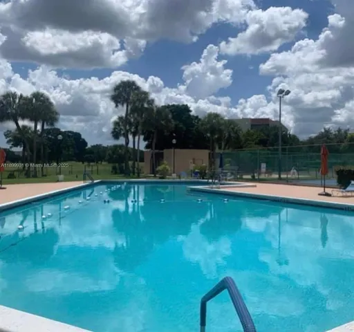 a view of a swimming pool with a yard