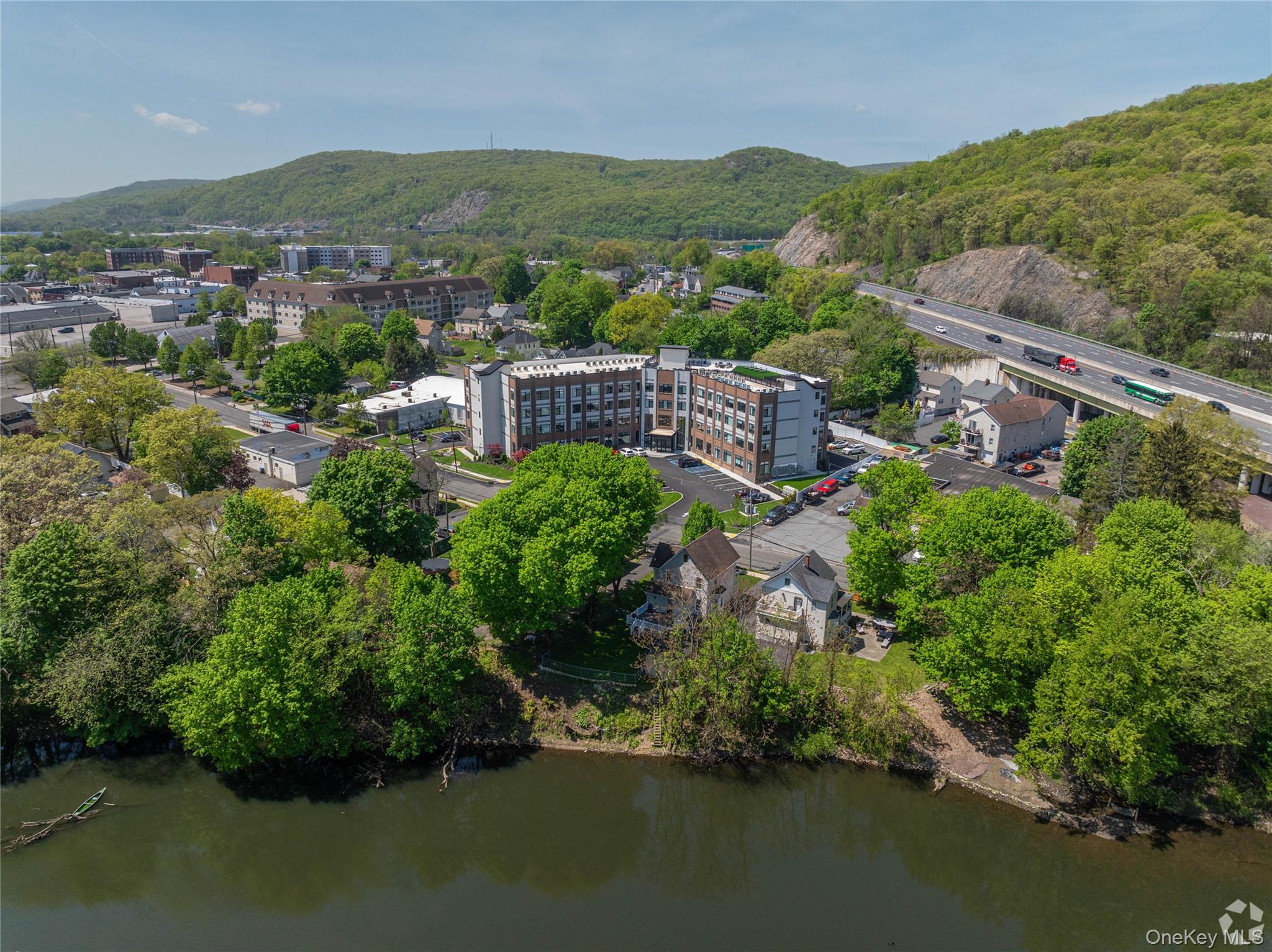 15 Washington Avenue, Unit 314 Suffern, NY 10901 - Photo 29 of 31 an aerial view of green landscape with trees houses and lake view