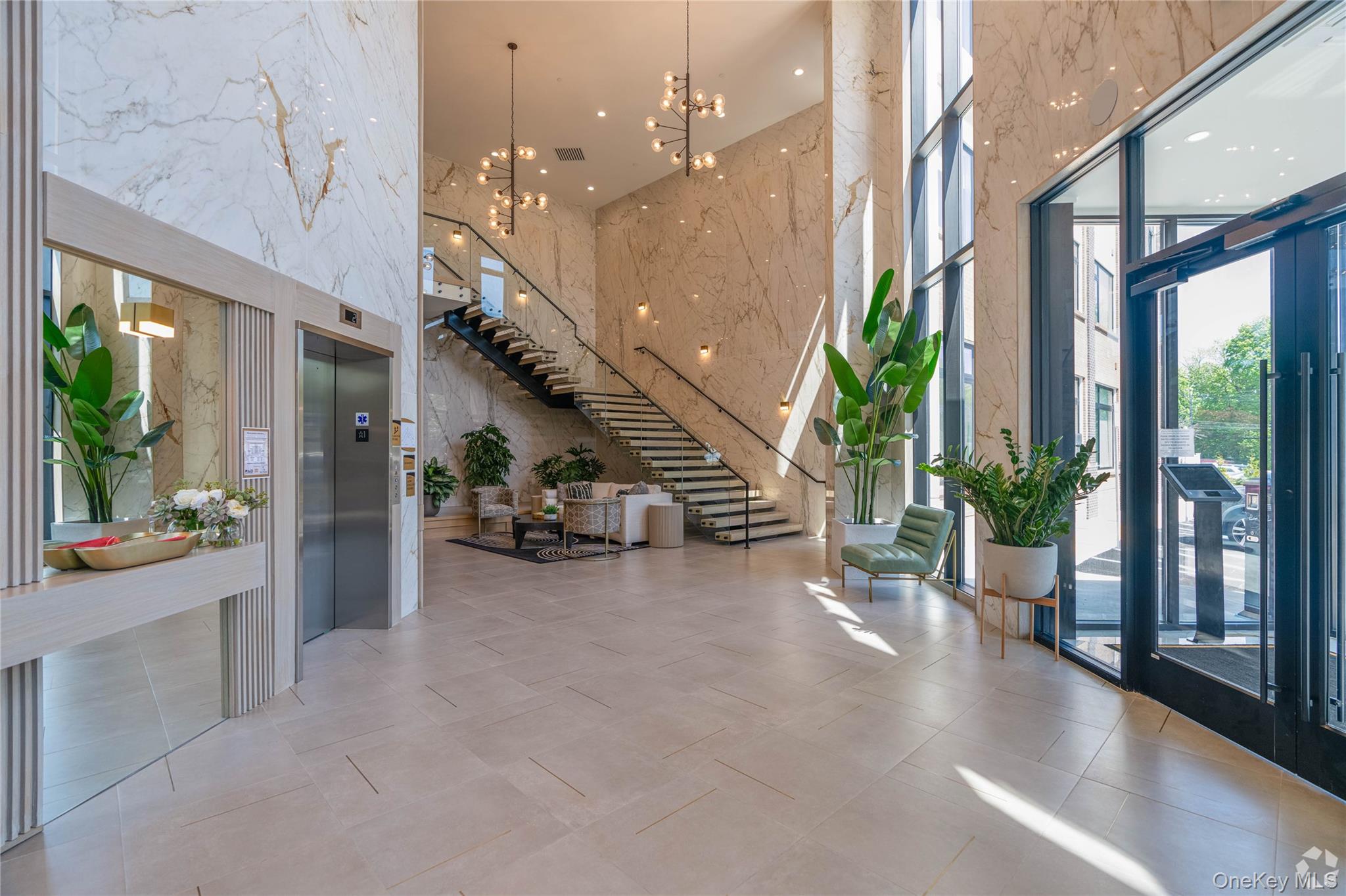 15 Washington Avenue, Unit 314 Suffern, NY 10901 - Photo 4 of 31 a view of a hall with floor to ceiling windows and a table