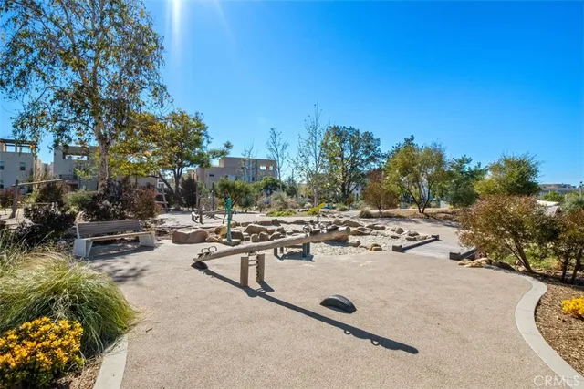 a view of a garden with a building in the background