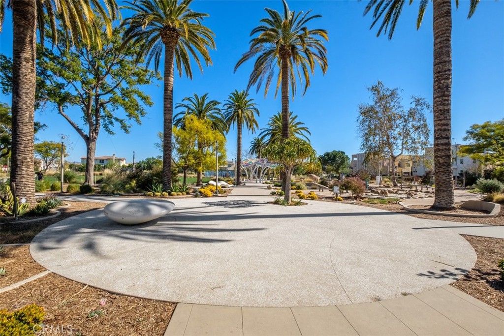 179 Follyhatch Irvine, CA 92618 - Photo 42 of 48 a view of a swimming pool with a lawn chair and palm trees