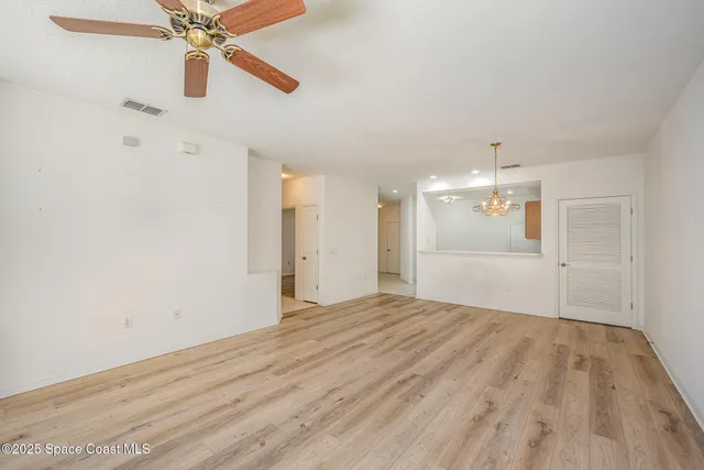 a view of an empty room and wooden floor