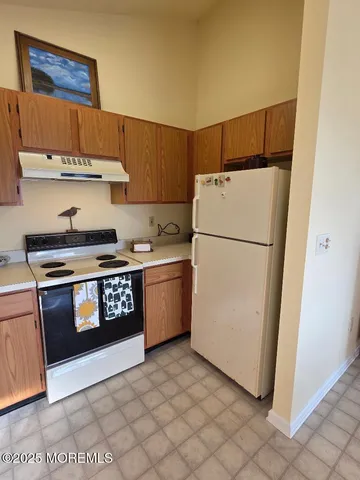 a kitchen with stainless steel appliances a refrigerator and a stove