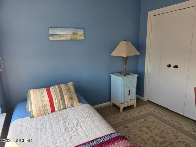 a bedroom with a bed and a lamp on table